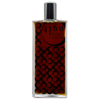 A rectangular perfume bottle labeled "Black Velvet Cafe" by 4160Tuesdays, featuring a black and red circular pattern design on the glass, houses the enchanting Eau de Parfum created by Sarah McCartney.