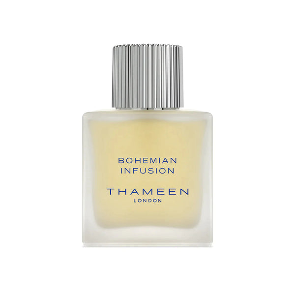 A square glass bottle with a silver cap labeled "Bohemian Infusion THAMEEN" containing a light yellow liquid. Crafted by the renowned perfumer Maurice Roucel, this fragrance contrasts delicate and bold notes, creating an alluring scent experience.