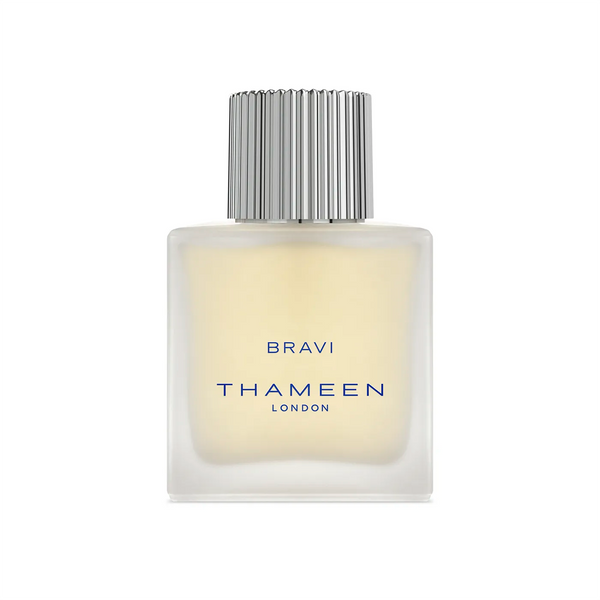 A square, frosted glass bottle of THAMEEN Bravi Cologne Elixir with a silver ribbed cap and blue text, capturing the allure of intoxicating tuberose.
