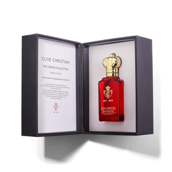 An open box reveals a red perfume bottle with a gold cap on the right and a description on the left that reads "Clive Christian Town & Country," highlighting the refined legacy of Crown Perfumery.
