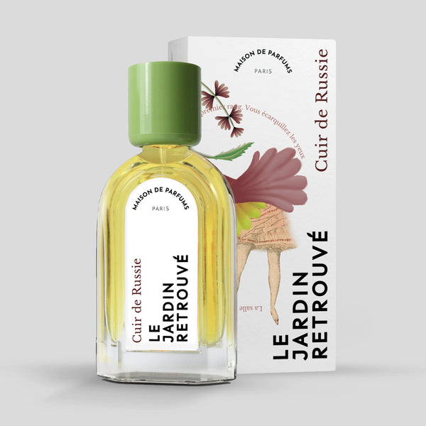 A perfume bottle labeled "Cuir de Russie" by Le Jardin Retrouvé with a green cap stands elegantly. The box behind it, adorned with floral artwork and text, complements the sophisticated essence of this Eau de Parfum.