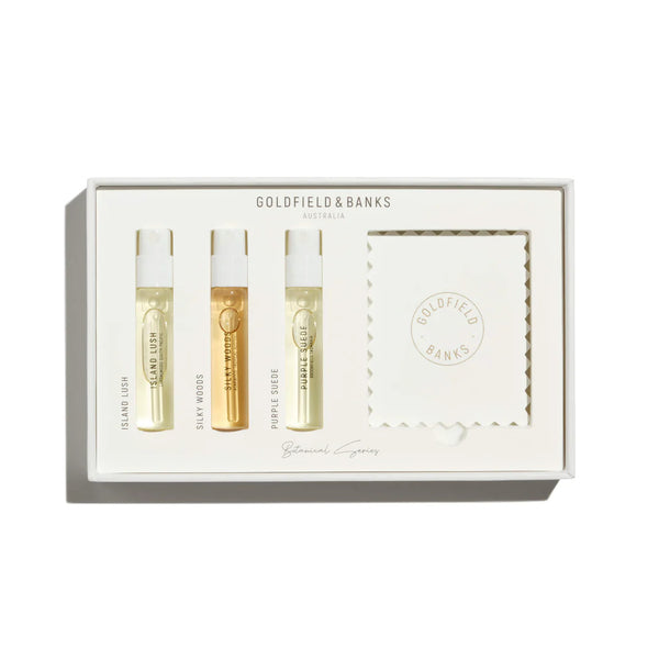 A white box contains three small bottles of Goldfield & Banks perfume samples labeled "Island Lush," "Silky Woods," and "Purple Suede," along with a folded card featuring the brand's logo. This Botanical Series Luxury Sample Collection 3 x 2ml epitomizes the essence of Australian perfumery.