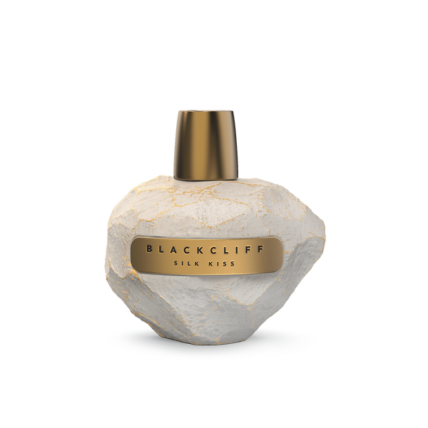 The "Silk Kiss" perfume by Blackcliff, with its white textured base and gold cap, embodies the opulent floral essence that has enchanted Caribbean women.