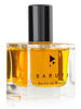 Clear glass bottle with gold-colored liquid perfume, black cap, and sleek black text that reads "Baruti Berlin im Winter." The intoxicating fragrance has a modern edge, exuding a boozy allure that captivates the senses.