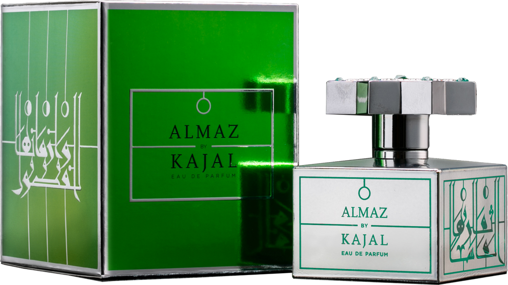 Image of a green perfume box labeled "Almaz by Kajal - Classic Collection" alongside a square-shaped glass perfume bottle with a silver cap decorated with green-blue gems. The bottle, also labeled, evokes a sense of everlasting love with its adornment of precious gemstones.