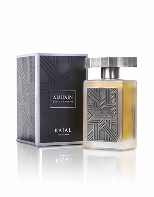 A bottle of Alujain by Kajal - Fiddah Collection, known for its traditional and modern fragrances, with a metallic rectangular design stands next to its matching box.