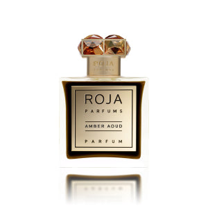 A bottle of Roja Amber Aoud, an oriental fragrance with a gold label and a decorative cap, offers a sensual blend that captivates the senses.