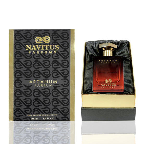 A bottle of Arcanum by Navitus Parfums is shown in its open box. The box is black and gold, displaying the perfume name and brand in gold letters. The square-shaped bottle, with its dark amber hue, hints at the rich cinnamon spice and dark amberwoods within.