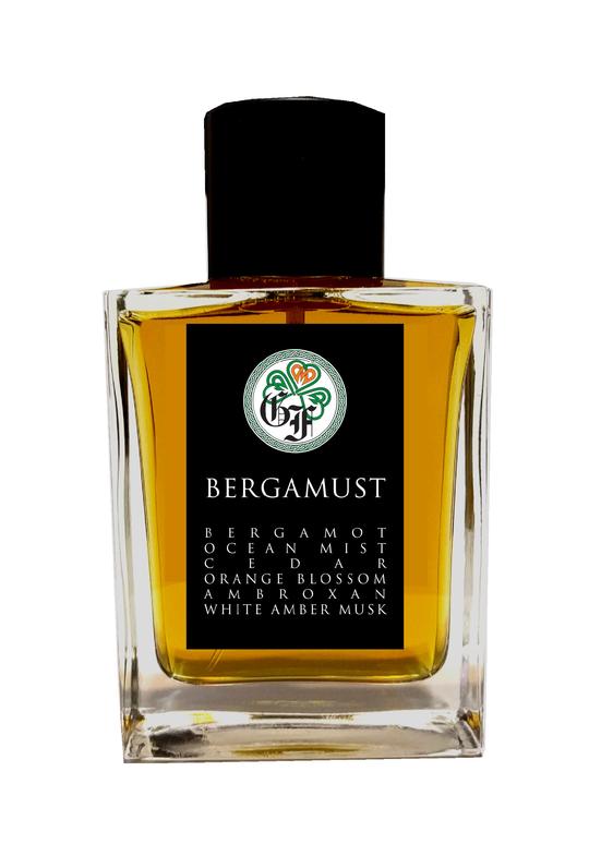 A clear rectangular glass bottle containing yellow liquid, labeled "Bergamust" by Gallagher Fragrances. The label lists ingredients: Bergamot, Ocean Mist, Cedar, Orange Blossom, Ambroxan, and White Amber Musk. This citrus fragrance with an aquatic essence captures the refreshing spirit of the sea and sun.