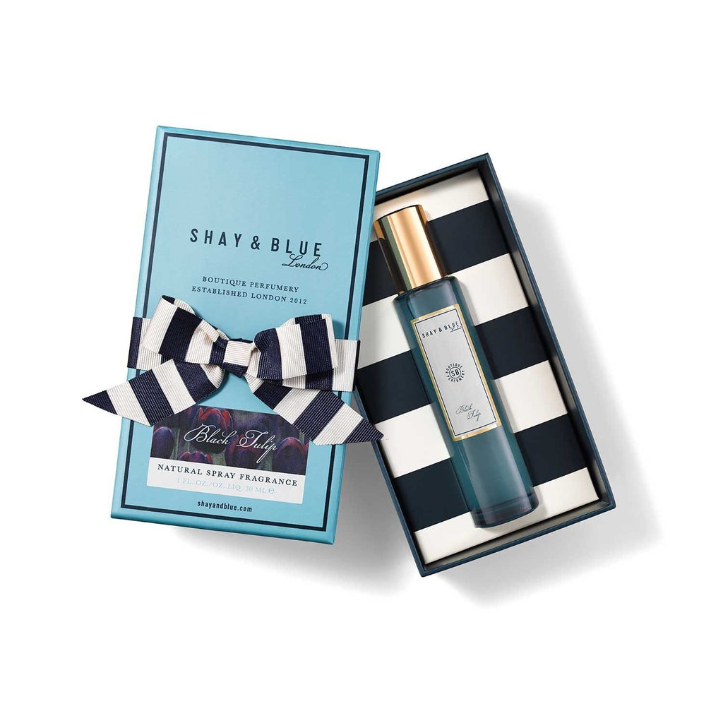 A blue Shay and Blue box with a ribbon and an open lid reveals an oriental floral fragrance inside, evoking the elegance of Black Tulip.