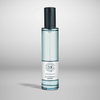 A clear bottle of Shay and Blue's Blackberry Woods vegan fragrance with a black cap, featuring a white label displaying the brand's logo and product name. The background is a plain, light grey.