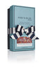 A turquoise Shay and Blue perfume box with a blue and white striped ribbon, labeled "Blood Oranges," reveals a vegan unisex fragrance inside.
