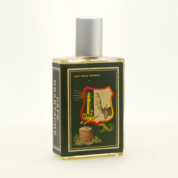A green glass bottle with a silver cap, featuring a label that depicts a shield, a tree stump with an axe, and a flying eagle. The text "Ales Volat Propriis" is above the shield, evoking the spirit of old-growth forests in the Pacific Northwest. Cape Heartache by Imaginary Authors embodies this imagery perfectly.
