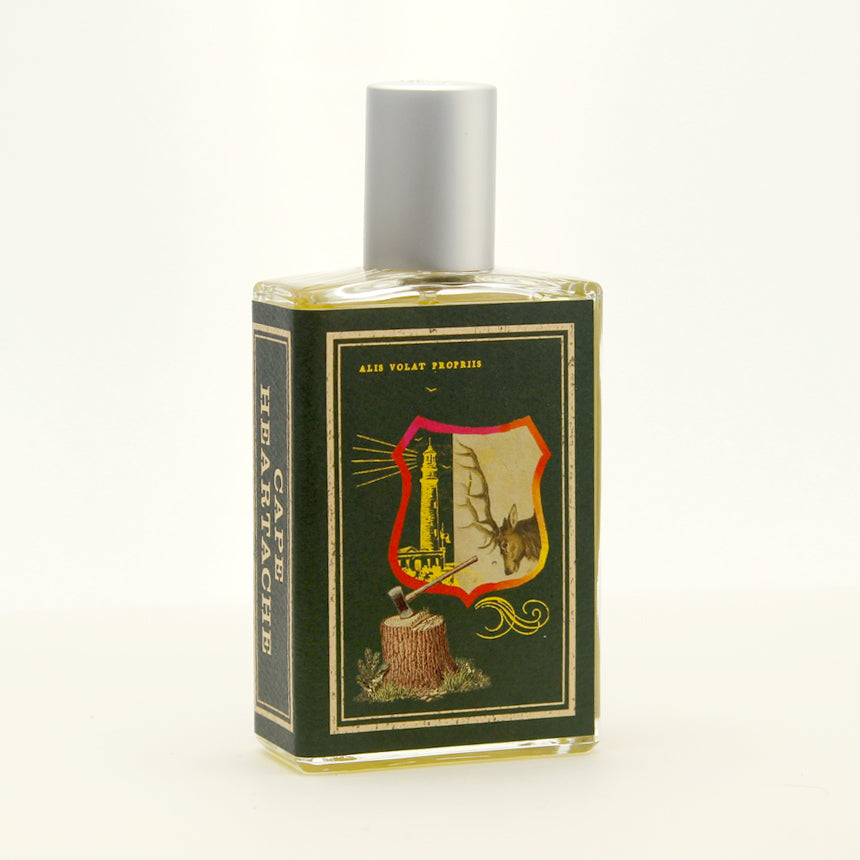 A green glass bottle with a silver cap, featuring a label that depicts a shield, a tree stump with an axe, and a flying eagle. The text "Ales Volat Propriis" is above the shield, evoking the spirit of old-growth forests in the Pacific Northwest. Cape Heartache by Imaginary Authors embodies this imagery perfectly.