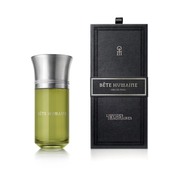 Photograph of a perfume bottle labeled "Bete Humaine" by Liquides Imaginaires, evoking a forest scent, next to its sleek black packaging.