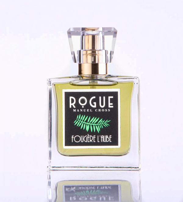 A bottle of Rogue Perfumery Fougere L’Aube perfume with a gold cap and green label featuring a fern design, infused with hints of Green Citrus.