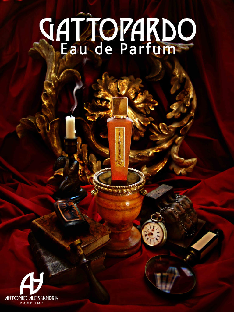 An ornate bottle of Antonio Alessandria's Gattopardo, celebrated for its Sicilian gourmand essence, is displayed against a red draped background alongside a lit candle, a magnifying glass, an old book, and decorative elements.