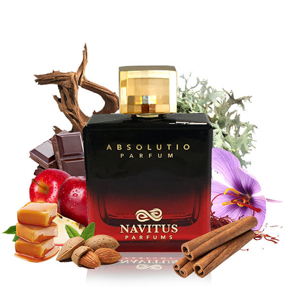 A bottle of Absolutio by Navitus Parfums sits surrounded by various ingredients like caramel, almonds, cinnamon sticks, apple, chocolate, and flowers, suggesting its long-lasting fragrance with hints of earthy delights.