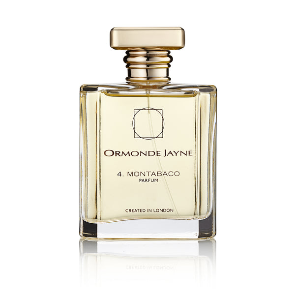A clear glass bottle with a metallic gold cap, containing Ormonde Jayne's Montabaco perfume. This seductive fragrance carries a Latin American essence. The label states "Created in London" by Ormonde Jayne.