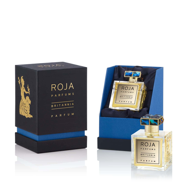 An open box and bottle of Roja Parfums Britannia, featuring a square glass bottle with a decorative cap beside its luxurious blue and black packaging. The fragrance elegantly combines notes of Ambergris and Mandarin, complemented by the exquisite Rose de Mai.