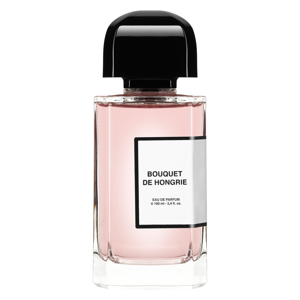 Clear glass bottle with a black cap contains pink perfume. The label reads "Bouquet de Hongrie, Eau de Parfum, 100 ml - 3.4 fl. oz." Perfect for a light dress on a breezy balcony evening. The product is "Bouquet de Hongrie" by BDK Parfums.