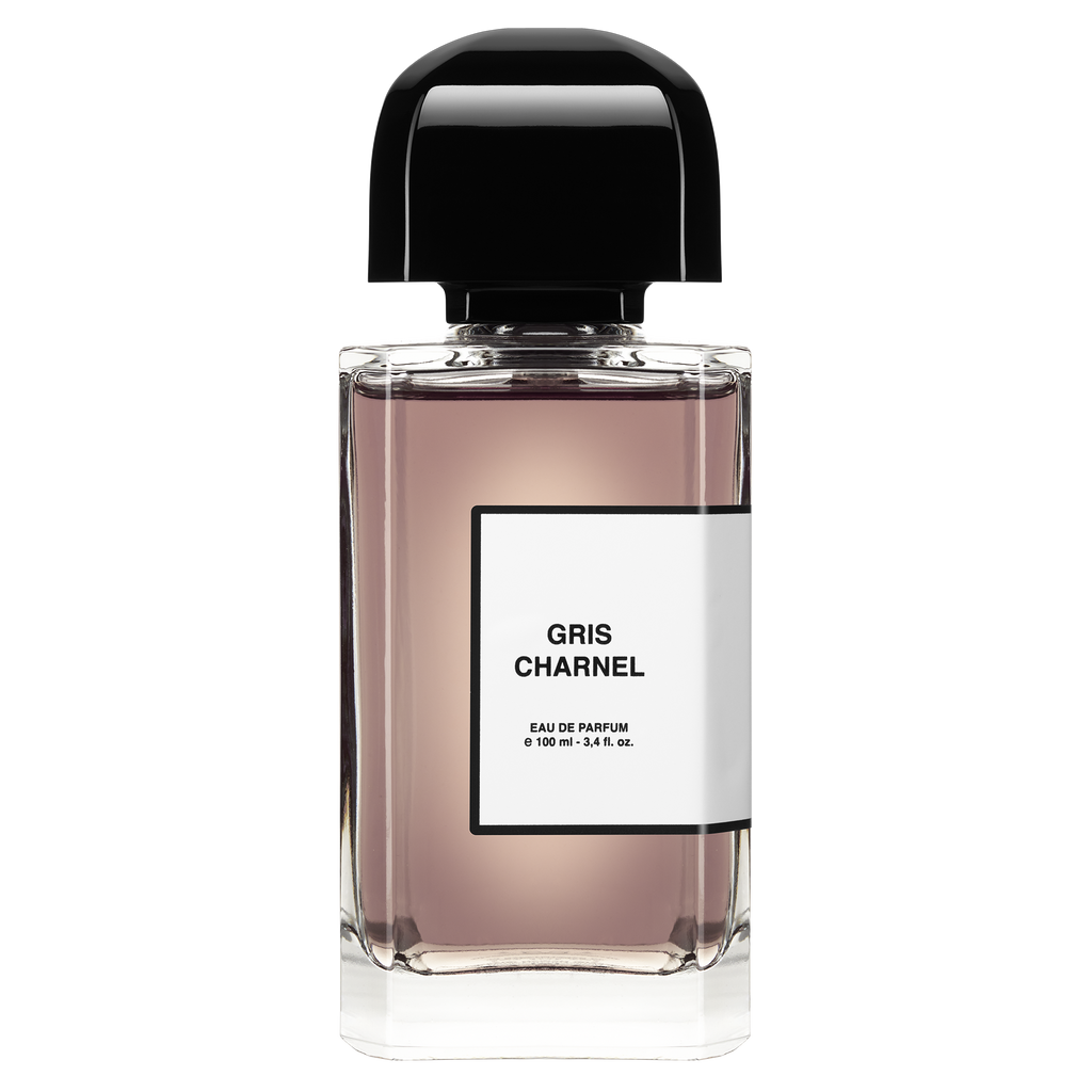 A clear glass bottle of Gris Charnel by BDK Parfums Eau de Parfum, 100 ml, with a black cap and a white label, evokes the essence of Jardin des Plantes and features notes of sandalwood from India.