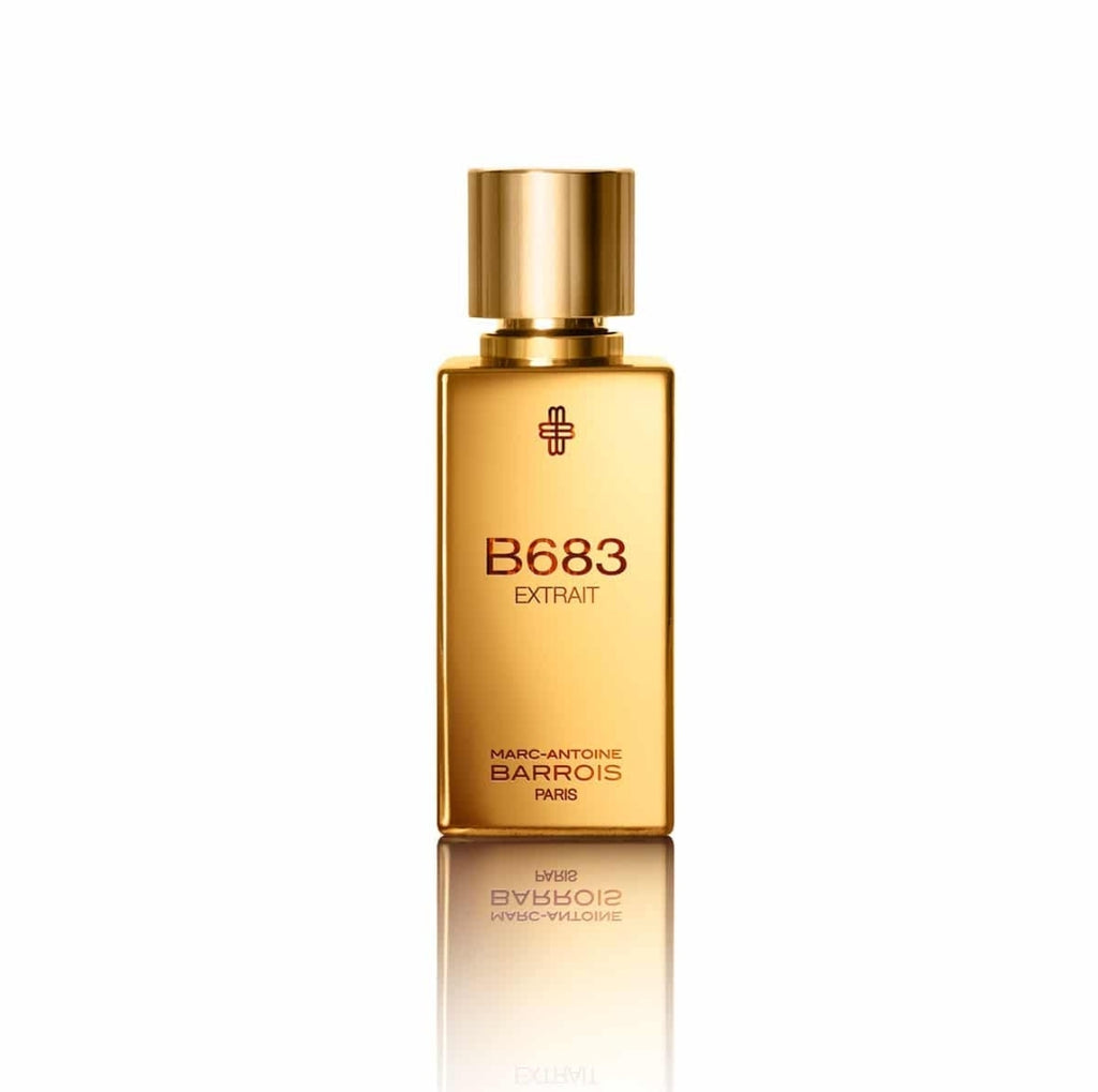 A gold rectangular bottle of B683 Extrait by Marc-Antoine Barrois, featuring a cylindrical gold cap and black text on the front, exudes a woody-leathery accord.