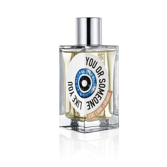 A rectangular perfume bottle with a metallic cap labeled "You or Someone Like You" by État Libre d'Orange, featuring an eye graphic on the front. Expertly curated by Chandler Burr, it offers a fresh floral fragrance that captivates the senses.