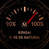 A gauge reads 90% to 100%, with the needle pointing at 98.5%. Text below the gauge states, "House of Matriarch's Bonsai is 98.5% natural, infused with Japanese Cypress.
