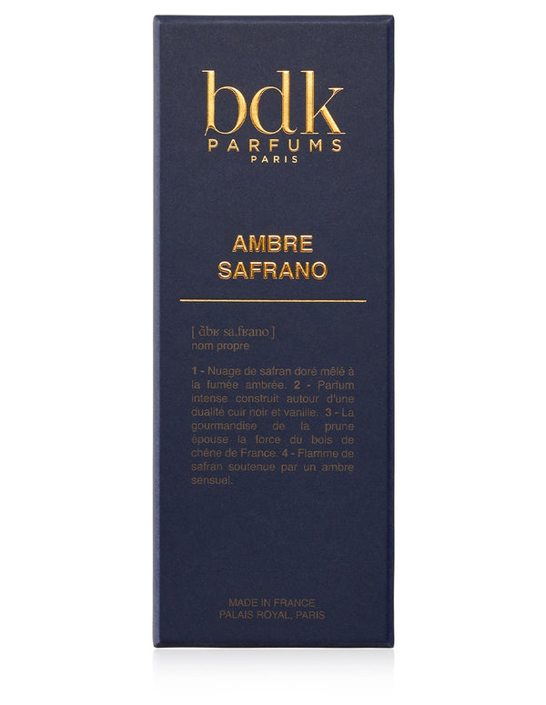 A dark blue rectangular box of Ambre Safrano by BDK Parfums with gold lettering reads "AMBRE SAFRANO". The box, adorned with descriptive text in French, celebrates this exquisite oriental fragrance made in France, Palais Royal, Paris.