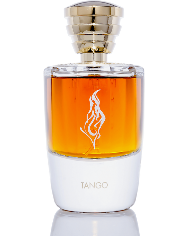A bottle of Masque Milano's Tango perfume features amber nectar liquid, a gold cap, and a flame logo etched onto its transparent glass bottle. The base is white with "TANGO" elegantly written in gold letters. This sensual fragrance promises to captivate with its alluring presence.