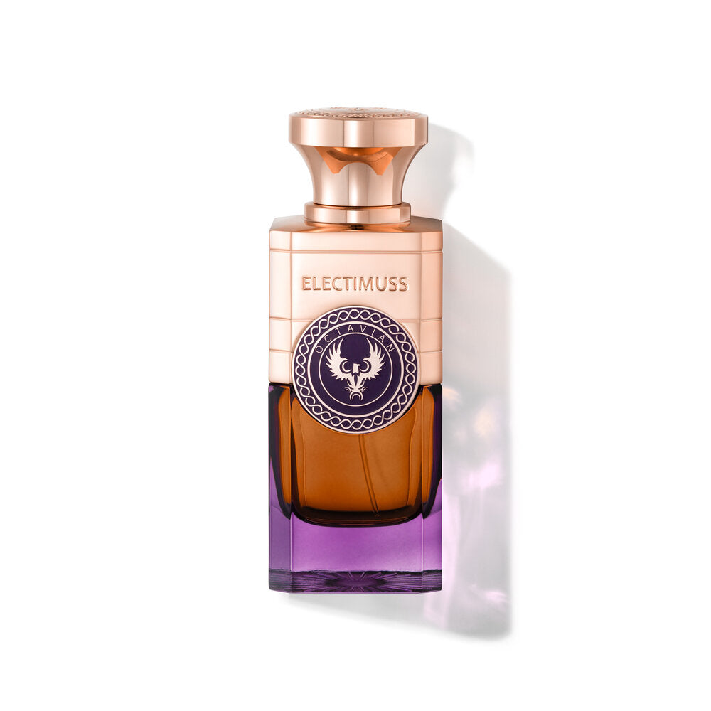 A bottle of Octavian by Electimuss, featuring a rectangular shape with a gold cap and a gradient color transition from purple to amber. The label, reflecting the grandeur of the Roman Empire during Emperor Augustus' reign, boasts a circular design inspired by ancient Persian incense rituals.