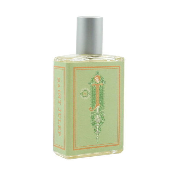 The rectangular perfume bottle by Imaginary Authors features a silver cap and a light green label, adorned with the words "Saint Julep" in orange letters on the side, suggesting sweet mint undertones.
