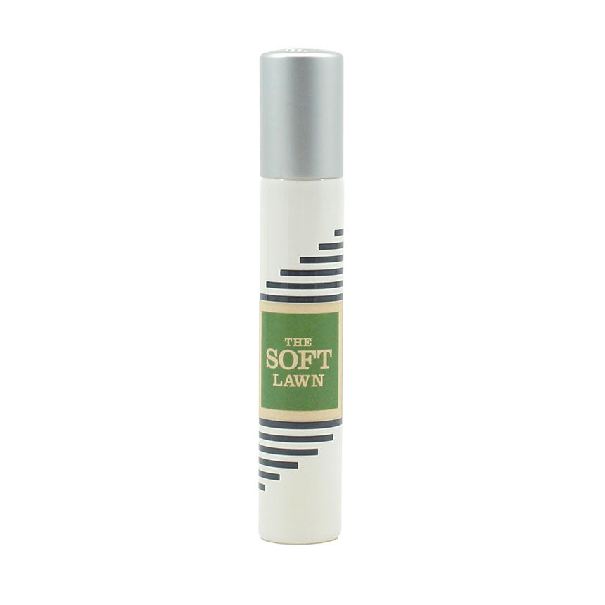 A small, white cylindrical bottle with a silver cap labeled "The Soft Lawn" by Imaginary Authors and featuring black horizontal lines on the side, evokes the freshness of linden blossom.