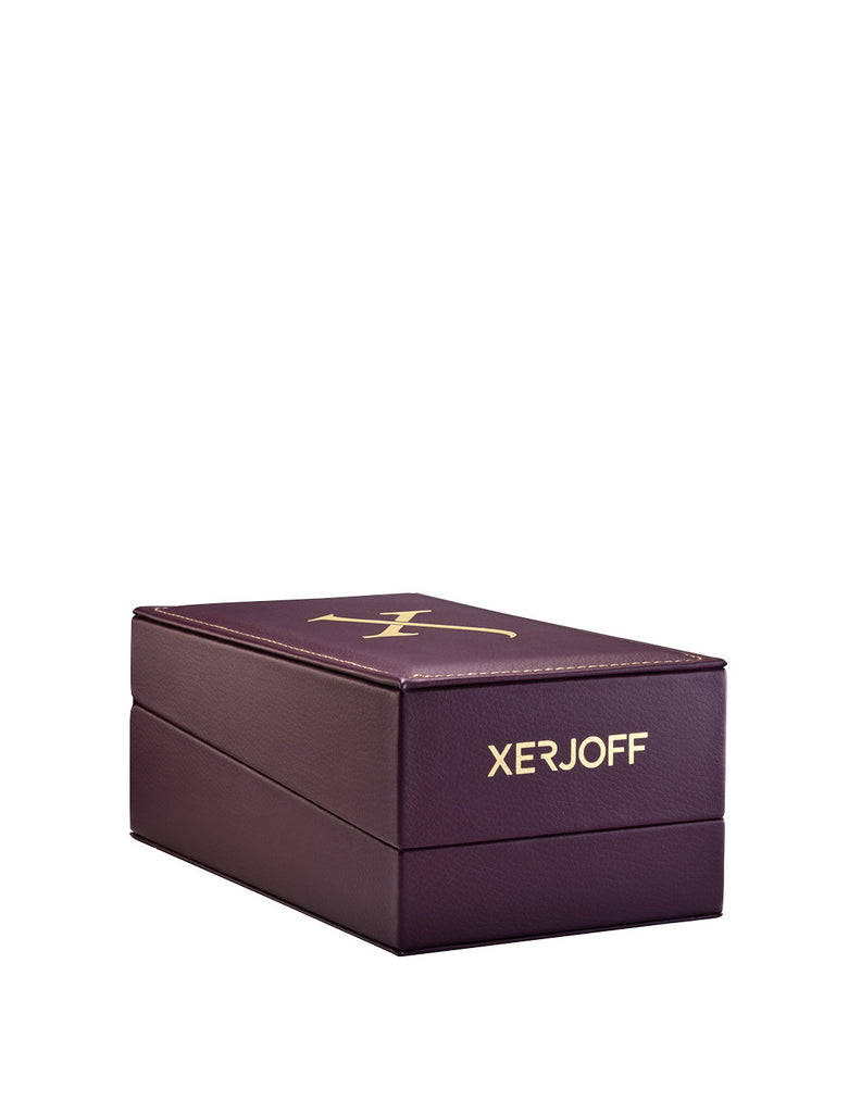 A closed, rectangular, purple box with gold text "Xerjoff" and a gold logo on the lid, reminiscent of a modern perfume collection housing Uden from Xerjoff.