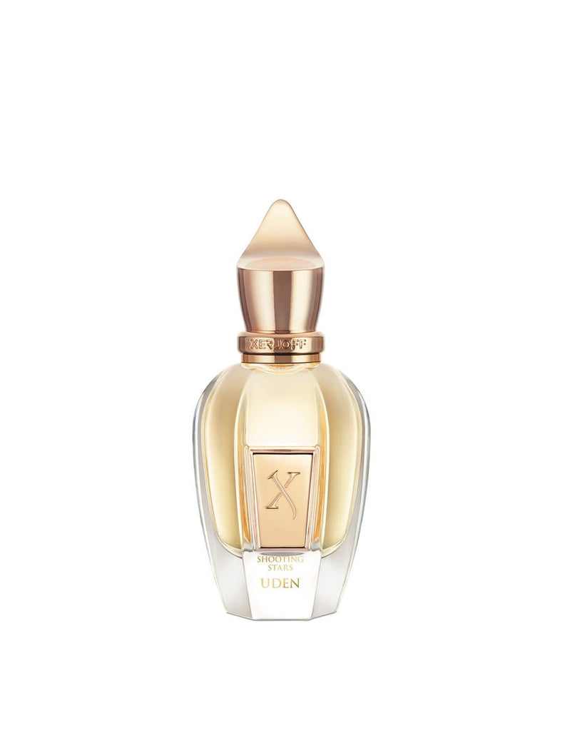 A transparent, elegantly designed modern perfume bottle with a gold-toned cap and label, embossed with the word "Uden" and a logo featuring the number "X". The scent within evokes tropical citrus notes and a saline aquatic fougère essence. Product Name: Uden Brand Name: Xerjoff