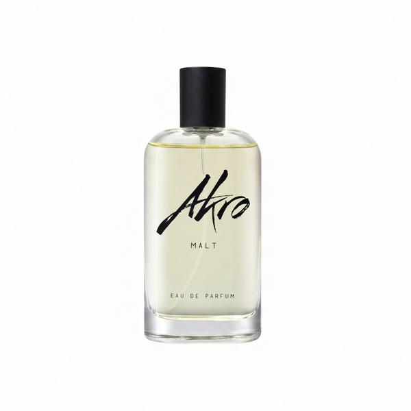 Clear glass bottle of Akro MALT Eau de Parfum with a black spray top and minimalist labeling, exuding a rich whisky fragrance.