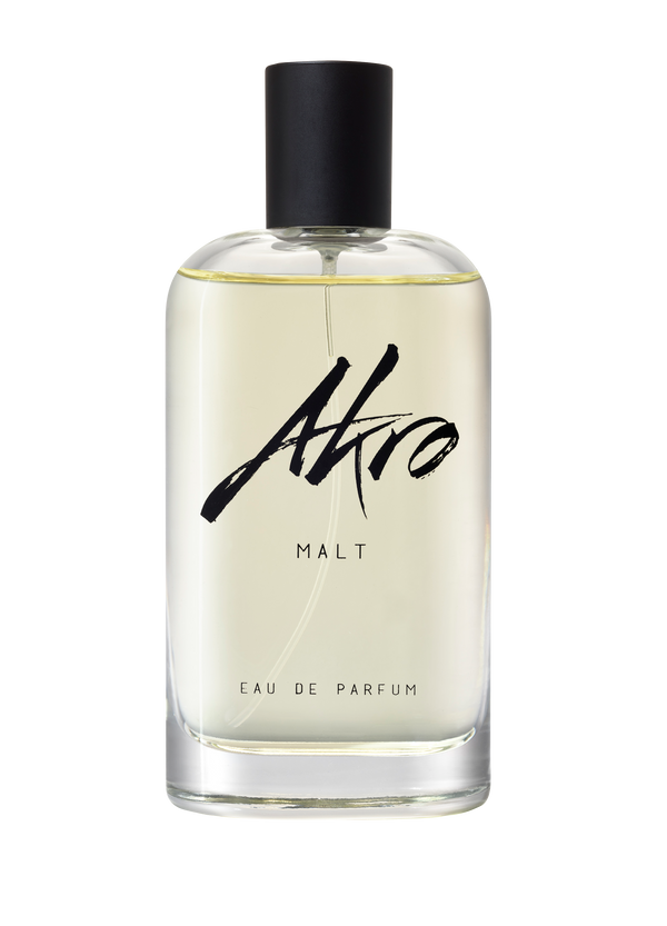 Clear glass bottle of Akro MALT Eau de Parfum with a black spray top and minimalist labeling, exuding a rich whisky fragrance.