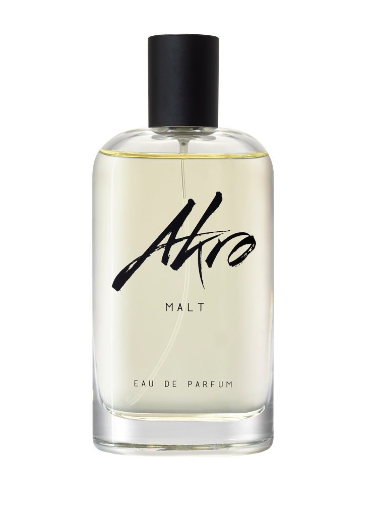 Clear glass bottle of Akro MALT Eau de Parfum with a black spray top and minimalist labeling, exuding a rich whisky fragrance.