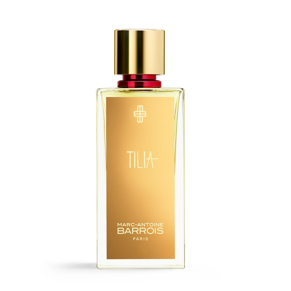 A clear glass bottle of Marc-Antoine Barrois TILIA, featuring a gold label and cap, captures exquisite floral scents.