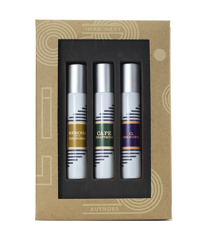 The Sava Trilogy Travel Set from Imaginary Authors comprises three fragrance bottles, labeled "Memoirs of a Trespasser," "Cape Heartache," and "O, Unknown," packaged in a cardboard box.