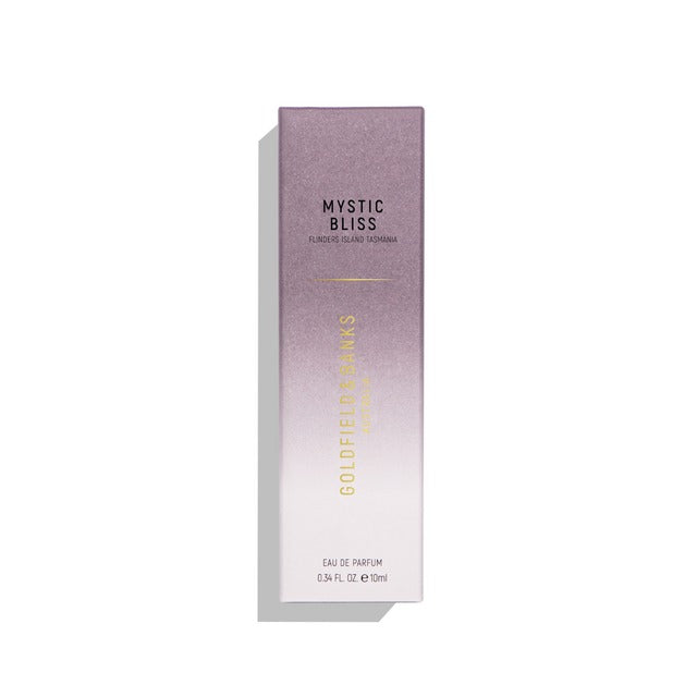 A boxed bottle of Goldfield & Banks Mystic Bliss Eau de Parfum 10 ml, infused with rich botanical essences and Australian Kunzea. The packaging showcases a gradient design transitioning from purple to white, adorned with text in gold and black.