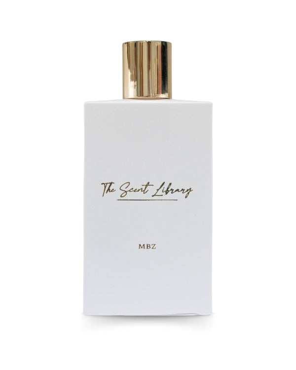 A white perfume bottle with a gold cap, labeled "The Scent Library" and "MBZ" in gold text, honoring Sheikh Mohamed bin Zayed Al Nahyan's UAE legacy.