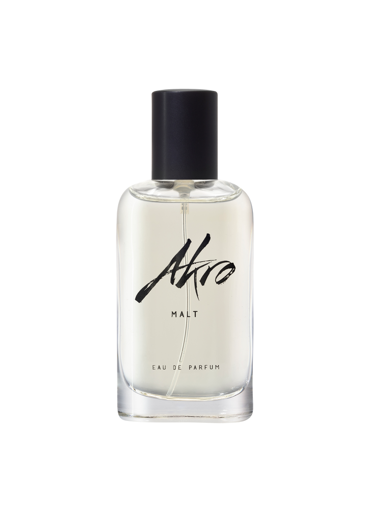 A clear glass bottle of Akro's MALT Eau de Parfum, boasting a smoky aroma, featuring a black cap and minimalist label design.