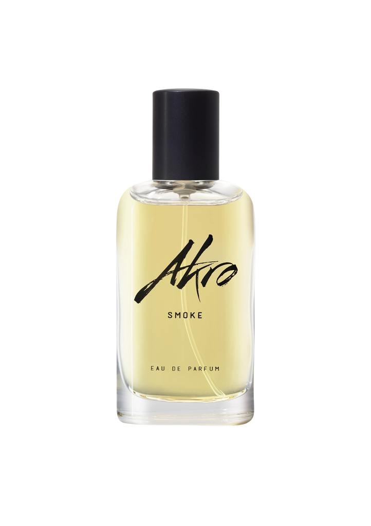 A bottle of Akro's SMOKE Eau de Parfum with a black cap and light yellow liquid inside. The label on the front reads "Akro SMOKE Eau de Parfum." This aromatic eau de parfum features a rich tobacco fragrance, designed to be the perfect unisex perfume for any occasion.