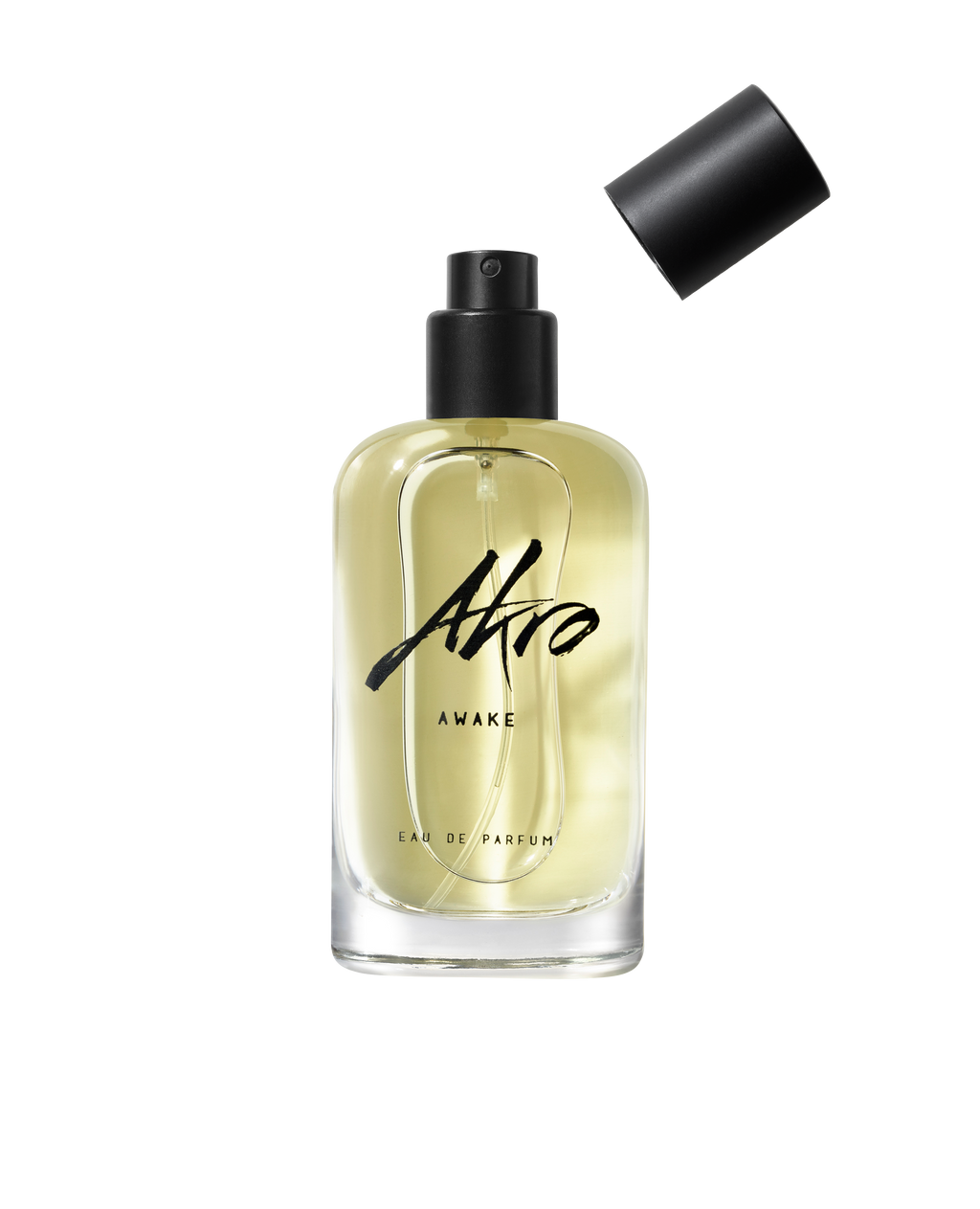 A clear bottle of Akro AWAKE unisex Eau de Parfum with a black spray nozzle and the cap removed, displaying light yellow liquid inside, emanates an energizing coffee fragrance.