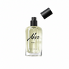 A clear glass bottle of Akro DARK Eau de Parfum featuring a black spray nozzle, with the cap placed nearby. The bottle is partially filled with a light-colored liquid, capturing the allure of mature sensuality intertwined with an addictive dark chocolate fragrance.