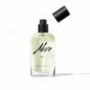 A clear bottle of Akro INK Eau de Parfum, adorned with black text on the front and featuring a detached black cap above it, captures the essence of a tattoo fragrance.