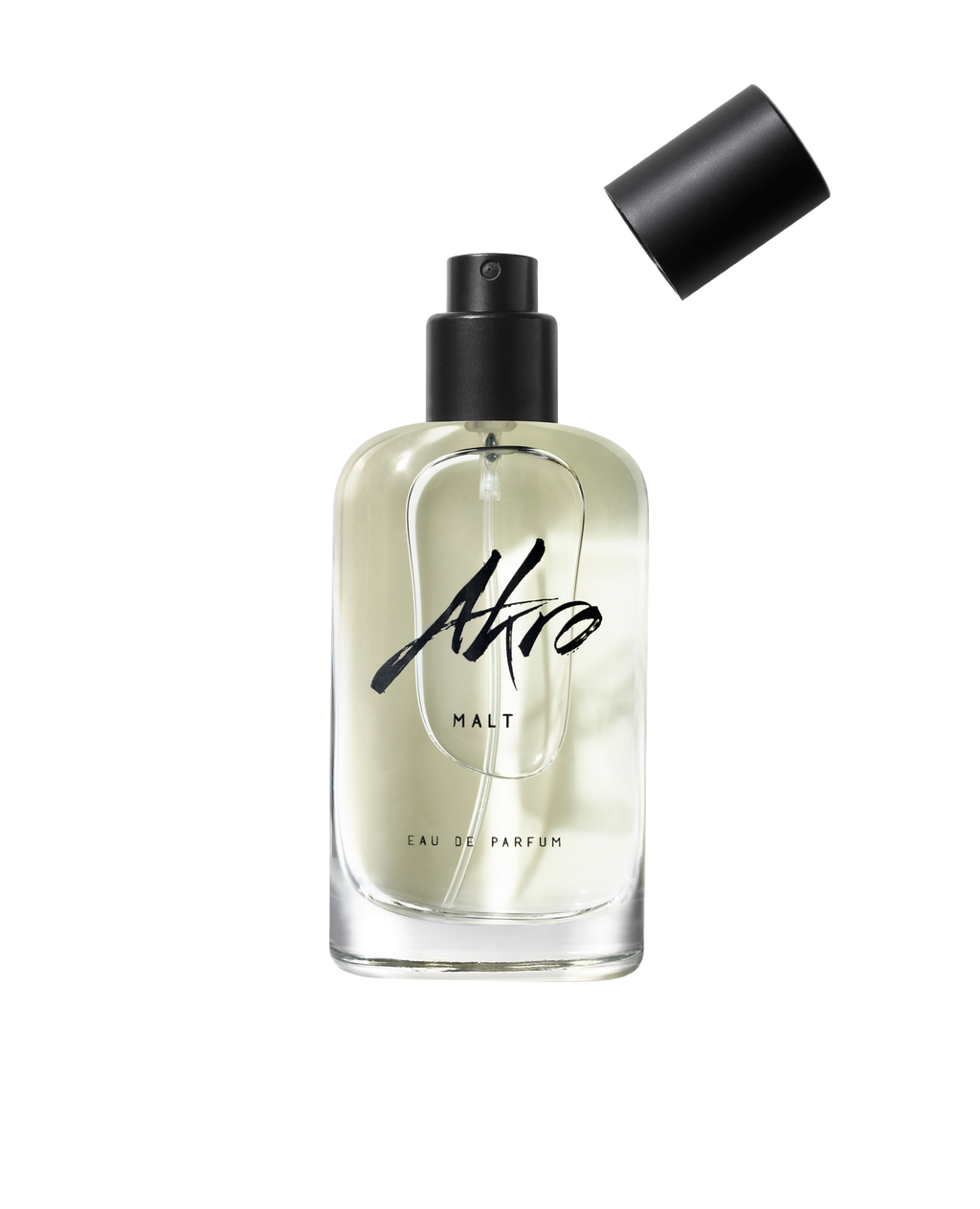 MALT by Akro, a clear glass bottle of Eau de Parfum with a black spray pump, has its cap placed slightly askew beside it, exuding a sweet and smoky scent.