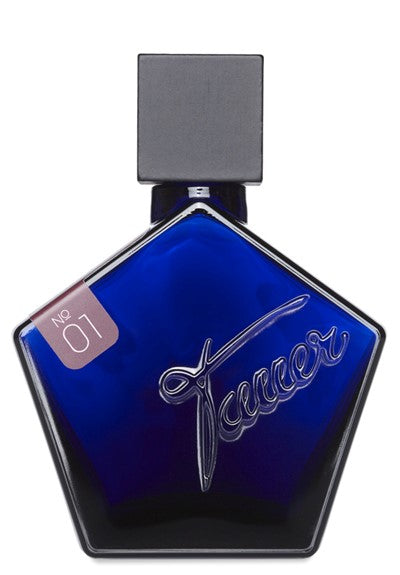 A blue pentagonal-shaped perfume bottle with a black cap and "Tauer Perfumes" embossed on the front. The bottle features a small label that reads "No 01," hinting at the exotic feminine scent of "Le Maroc pour Elle," which contains notes of Moroccan Rose and Jasmine.
